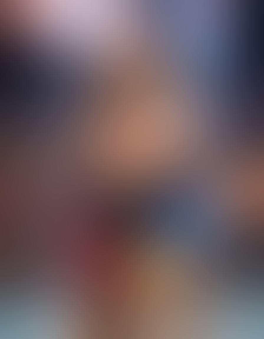 An intimate moment depicting wrestlers in a warm embrace, showcasing their camaraderie and respect after a match. Background filled with cheering fans, colorful banners, and the wrestling ring illuminated by spotlights, conveying the passionate atmosphere of wrestling culture. Include heartwarming expressions and gestures that reflect deep friendship and support. super-realistic. vibrant colors. dynamic composition.